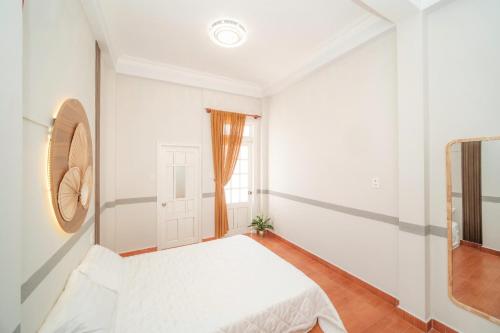 a bedroom with a bed and a window at Ngân Villa in Xuan An
