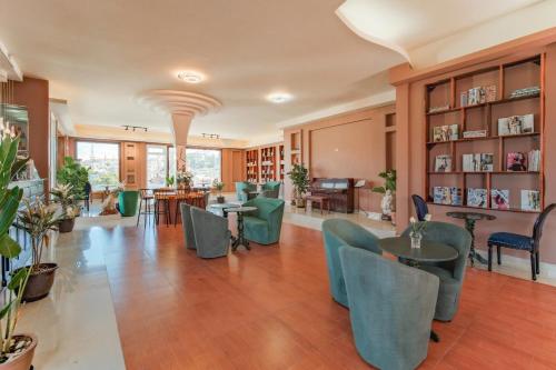 a living room with tables and chairs and a library at Ngân Villa in Xuan An