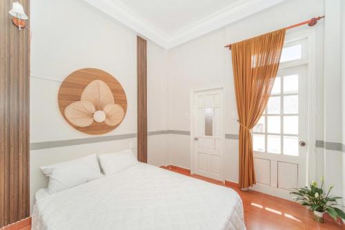 a bedroom with a white bed and a window at Ngân Villa in Xuan An