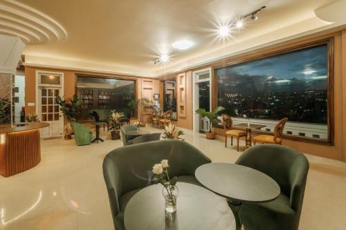 a living room with a table and chairs and a large window at Ngân Villa in Xuan An