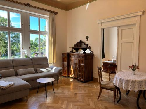 a living room with a couch and a table at Ferienwohnung Domaene Kermen in Leps