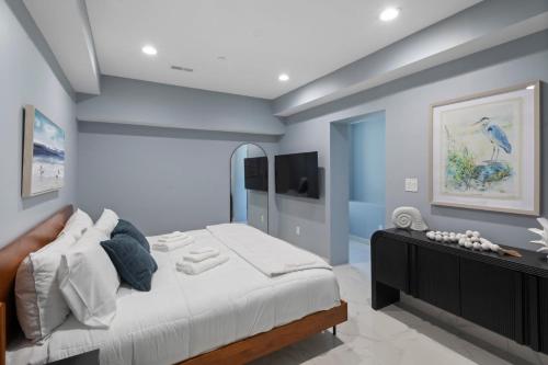 a bedroom with a large bed and a tv at Ammos Luxury Living- Crete Suite in Ventnor City