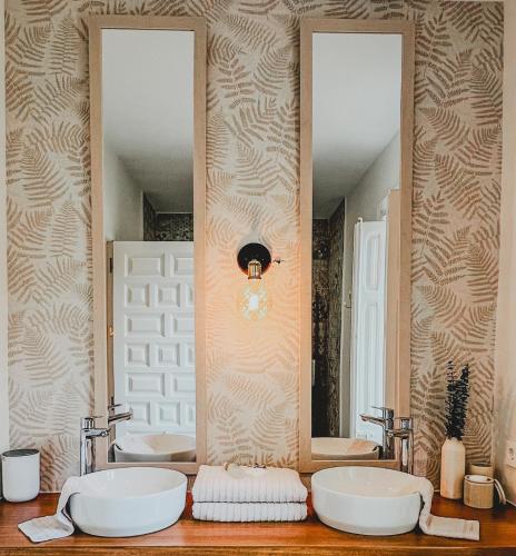 a bathroom with two sinks and two mirrors at Seraphina Bookings Mojacar in Mojácar
