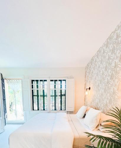 a bedroom with a white bed and a window at Seraphina Bookings Mojacar in Mojácar
