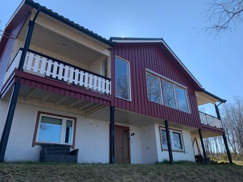 a house with a red and white at Comfortable B&B near Senja in Brostadbotn