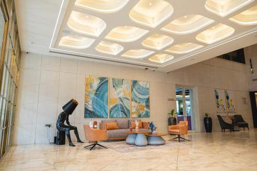 a lobby with a couch and chairs in a building at Kertel Suites Kinshasa in Kinshasa
