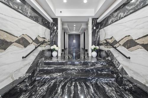 a lobby with a marble floor and stairs with flowers at Ammos Luxury Living- Zakinthos Suite in Ventnor City