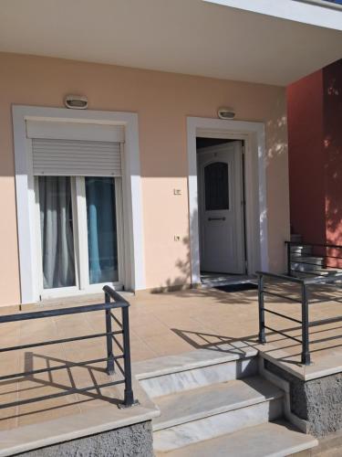 a building with stairs and a door and a building at Liberty Cozy Apartment in Kalloni