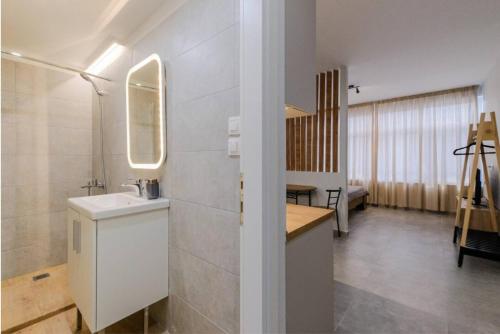 a bathroom with a sink and a mirror at Ladadika Vibes Studio 1 in Thessaloniki