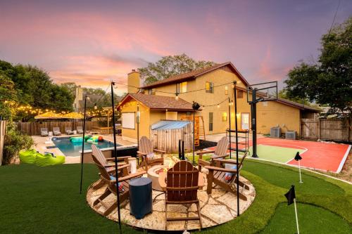 a house with a backyard with a swing yard at Sleeps 18-Basketball Court-Pool-Playground-Games in San Antonio