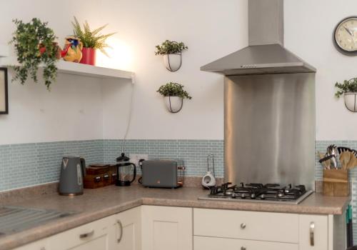 a kitchen with a stove and a counter top at The Lauderdale Street Residence in Edinburgh