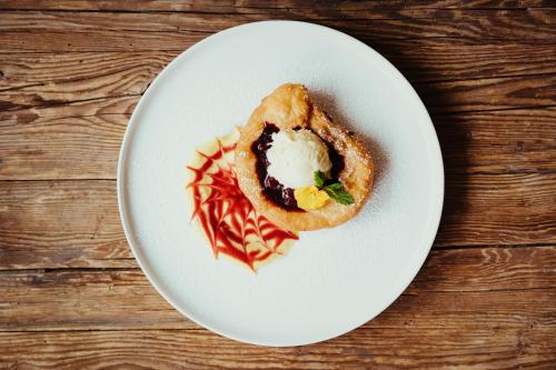 a white plate with a pastry on a table at Stella Due in Arabba