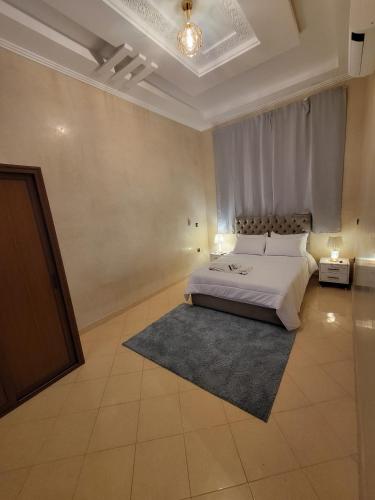 a large bedroom with a bed and a rug at Villa Marrakech Rimass - 6 Chambres Dont 5 Suites Luxe, Piscine Privee & Jardins in Marrakech