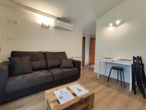a living room with a couch and a table at Hotel Rural Tierras del Cid in Quintanadueñas