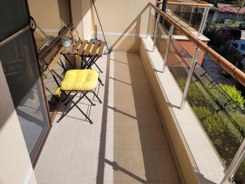 a balcony with a table and chairs on it at На море в Сарафово in Burgas City
