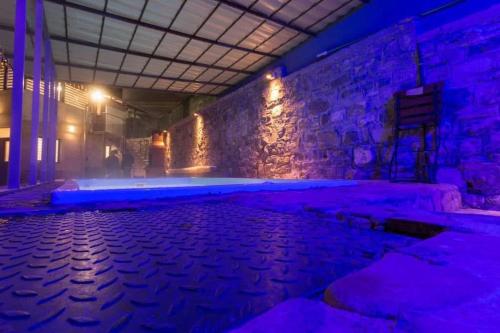 an empty room with purple lights on the wall at Casa SEMA in Sinaia