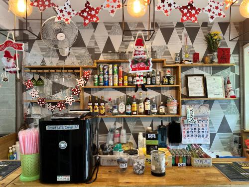 a coffee shop with a counter with a coffee machine at Sparta Patong in Ban Nong Chaeng
