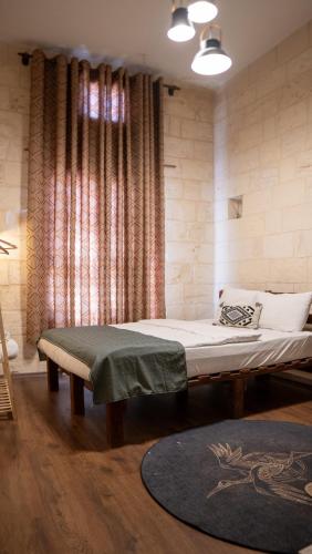 a bedroom with a large bed and a rug at Diib House Hotel in Urfa