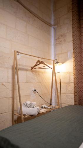 a room with a bed and a light on a wall at Diib House Hotel in Urfa