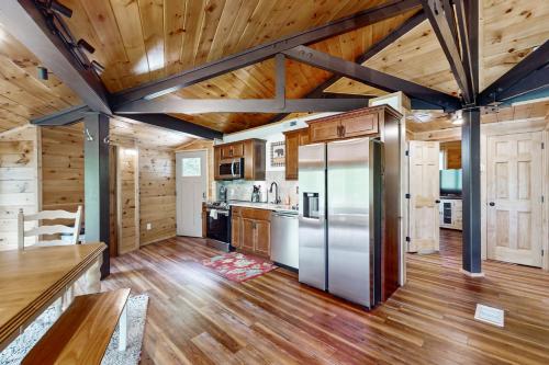 a kitchen with wooden ceilings and a refrigerator at Slopesider 20A in Sugar Mountain