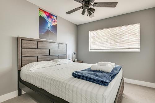 a bedroom with a large bed with a ceiling fan at Cocoa Home with Large Yard 3 Mi to Indian River! in Cocoa