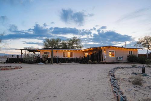 a house on the side of a dirt road at Twentynine Palms Desert Oasis with Pool and Hot Tub! in Twentynine Palms