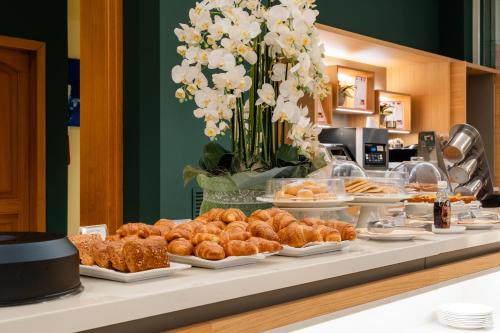 a buffet of pastries and pastries on a table at Hotel Terme Millepini in Montegrotto Terme
