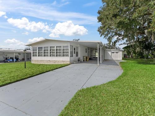 a large white building with a sidewalk in front of it at 907 Z1 Village of Silver Lake by REMAX Premier in The Villages