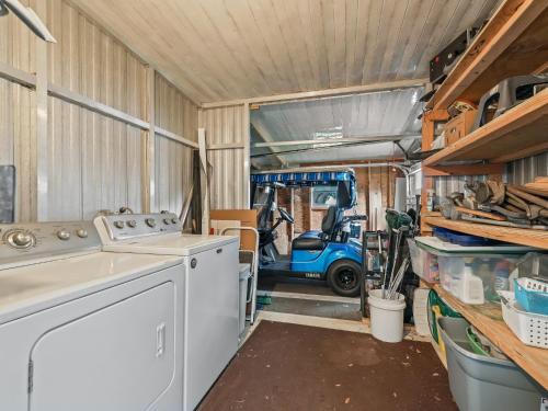 a washing machine in a garage with a car in it at 907 Z1 Village of Silver Lake by REMAX Premier in The Villages