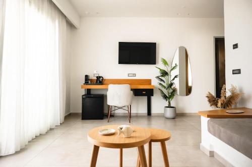 a living room with a bed and a desk at Batis Beach Hotel in Rethymno Town
