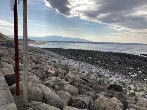 a group of rocks on a beach near the water at Gala House Strandhill in Strandhill