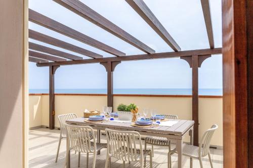 a dining room with a table and chairs at Italian Experience-La Terrazza Sul Conero in Porto Recanati