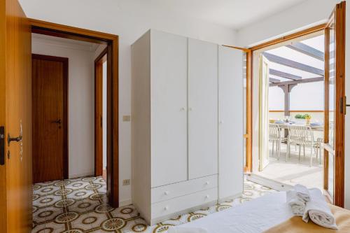 a bedroom with a white cabinet and a balcony at Italian Experience-La Terrazza Sul Conero in Porto Recanati