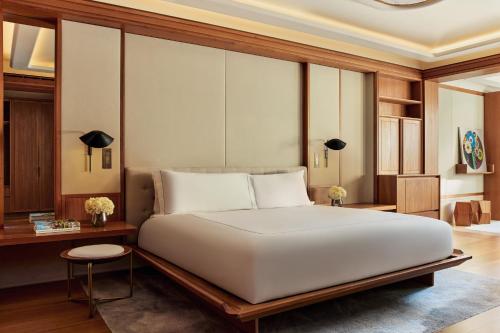 a bedroom with a large white bed and a desk at The Berkeley, Maybourne in London