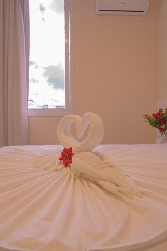 a swan made out of towels on a bed at Hotel Porto Napolis in Eunápolis