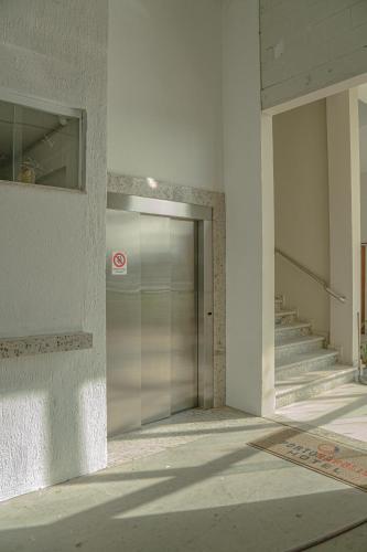 a building with a door and stairs in it at Hotel Porto Napolis in Eunápolis