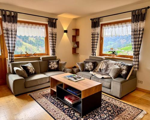 a living room with a couch and a table at Antler Apartment in Santa Fosca