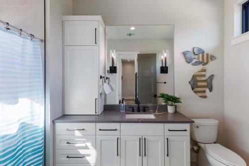 a bathroom with a sink and a mirror at Endless Sunset with Concierge Services in Marble Falls