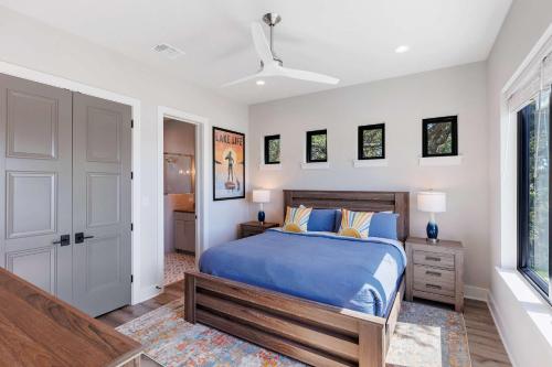 a bedroom with a blue bed and a window at Endless Sunset with Concierge Services in Marble Falls