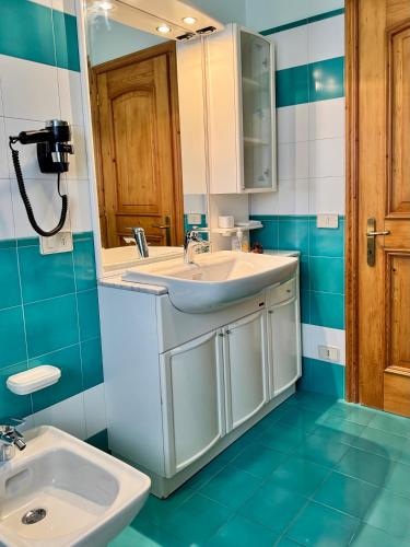 a bathroom with a sink and a mirror at Antler Apartment in Santa Fosca