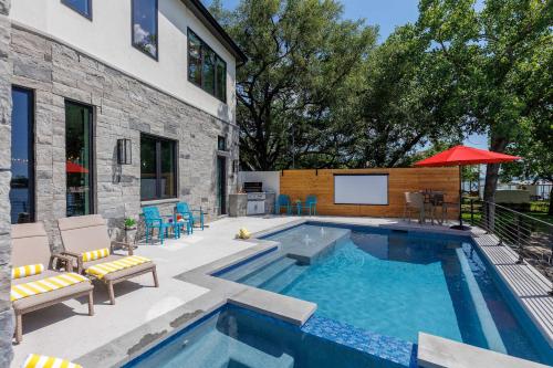 a swimming pool in front of a house at Endless Sunset with Concierge Services in Marble Falls