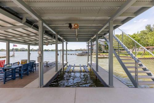 a dock with a table and chairs on the water at Endless Sunset with Concierge Services in Marble Falls