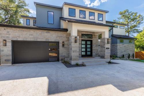 a house with a garage in front of it at Endless Sunset with Concierge Services in Marble Falls