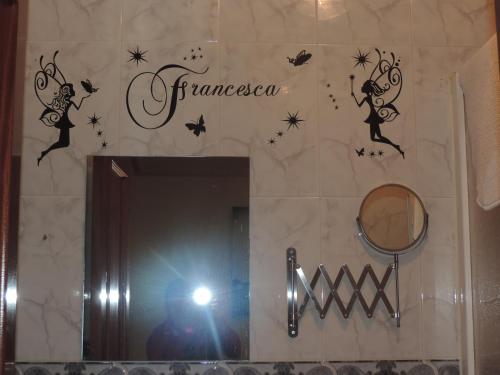 a person taking a picture of a mirror in a bathroom at Hostal Sali in Pelabravo