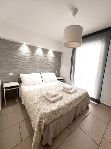 a bedroom with a bed with two towels on it at Salentoguests villetta sulla spiaggia in Porto Cesareo
