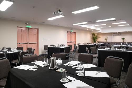 a room full of tables and chairs with black table cloth at Crowne Plaza Lima by IHG in Lima