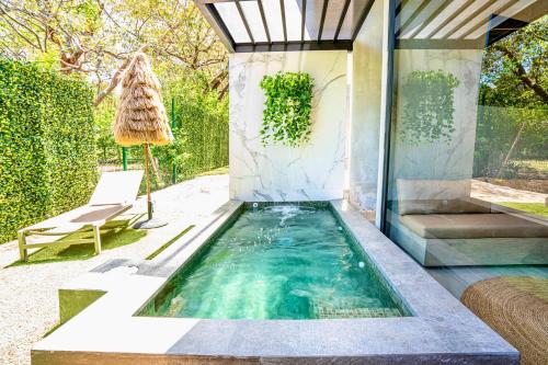 a pool in the backyard of a house at Epic Tamarindo Boutique Hotel in Tamarindo