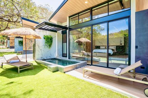 a house with a swimming pool in the yard at Epic Tamarindo Boutique Hotel in Tamarindo