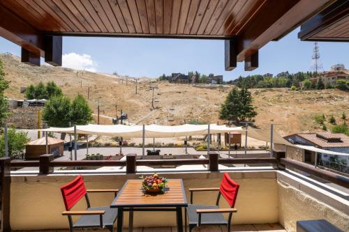 a patio with a table and chairs and a view at InterContinental Mzaar Lebanon Mountain Resort & Spa by IHG in Kfardebian