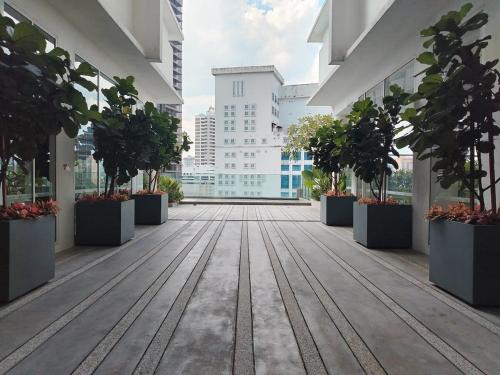 an empty corridor in a building with potted plants at Quill Residence- Minimalist Urban Condo by Azmila in Kuala Lumpur